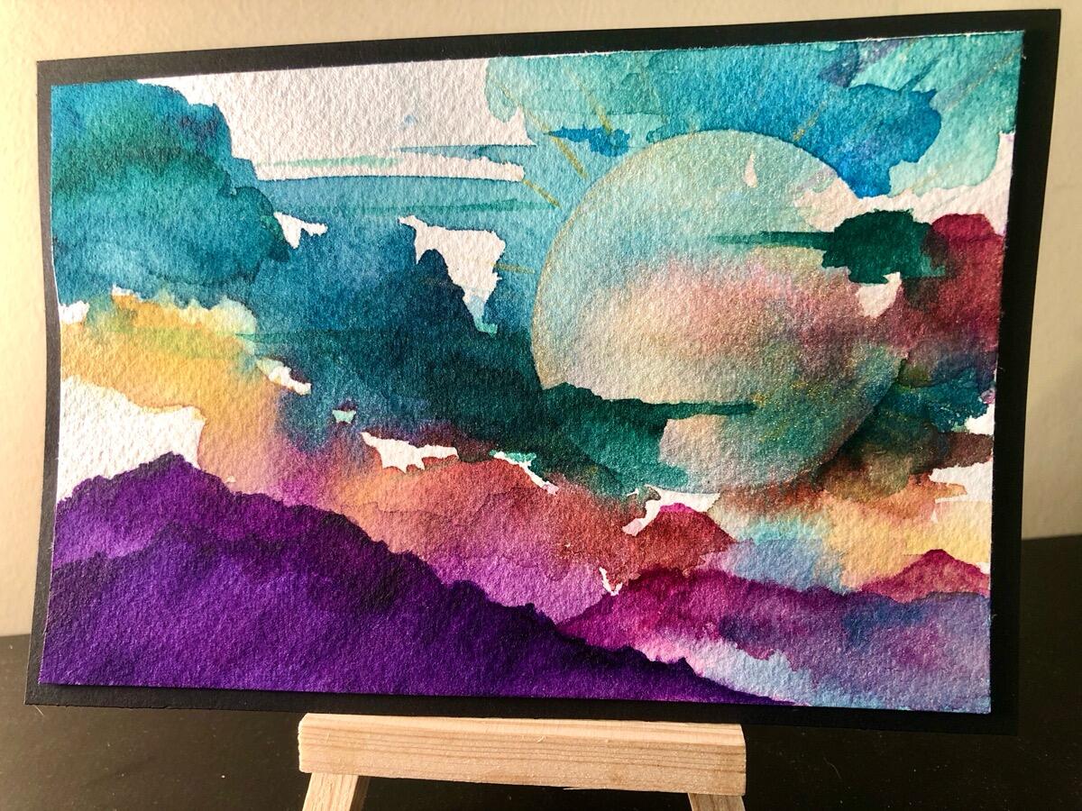 Teal and purple watercolor landscape under a moon
