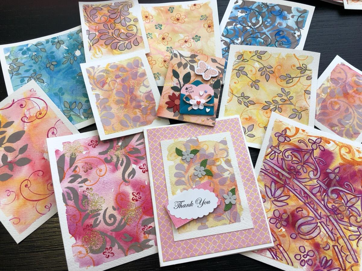 Spread of handmade pastel stencil cards
